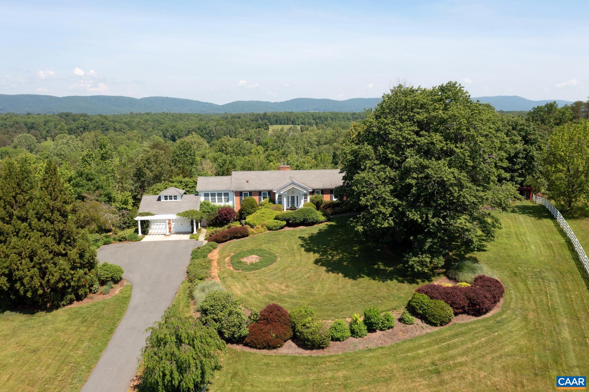 843 Campbell Road Keswick, VA 22947 - Photo 1 of 46 a view of a garden with mountains in the background