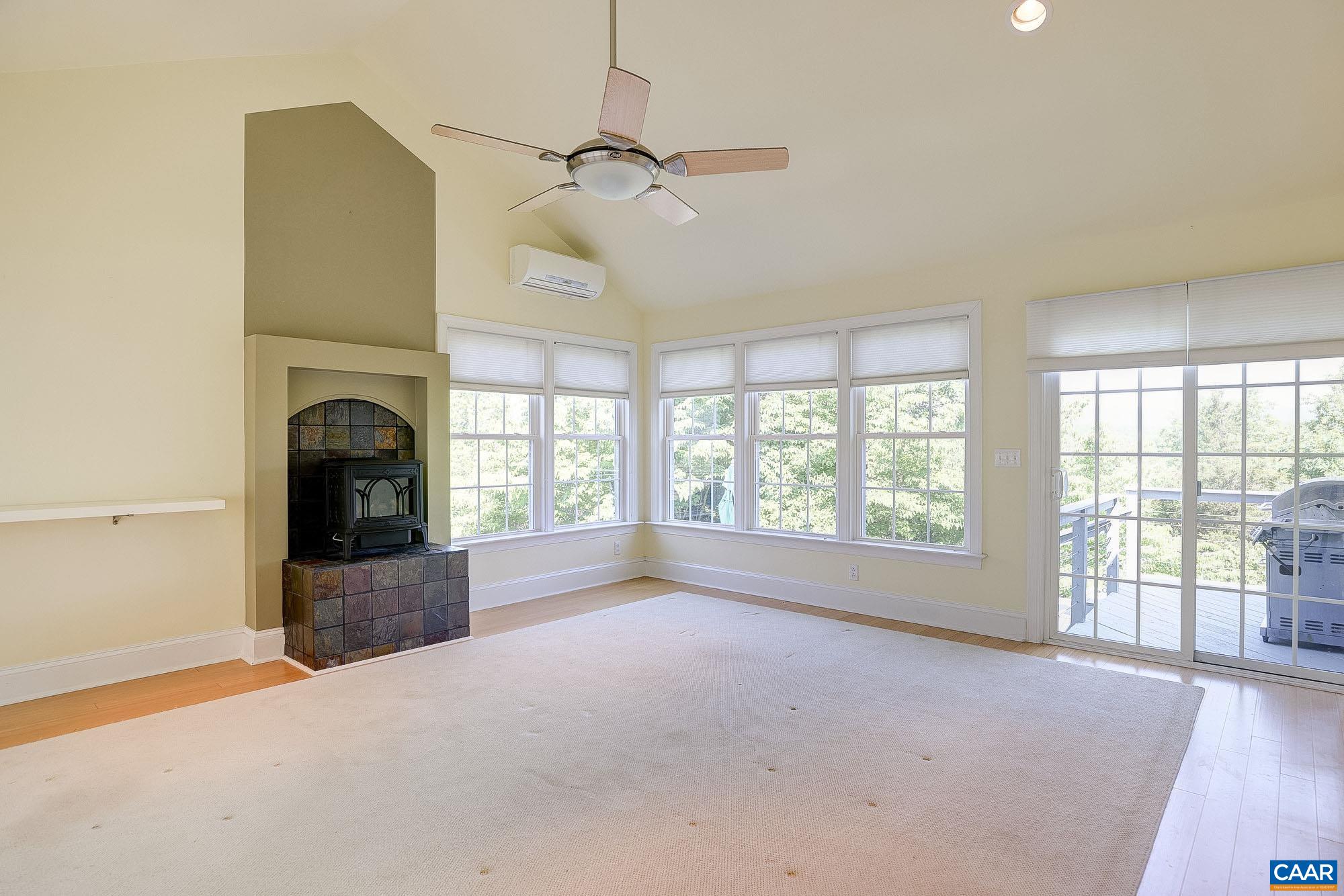 843 Campbell Road Keswick, VA 22947 - Photo 17 of 46 a view of a livingroom with a fireplace and windows