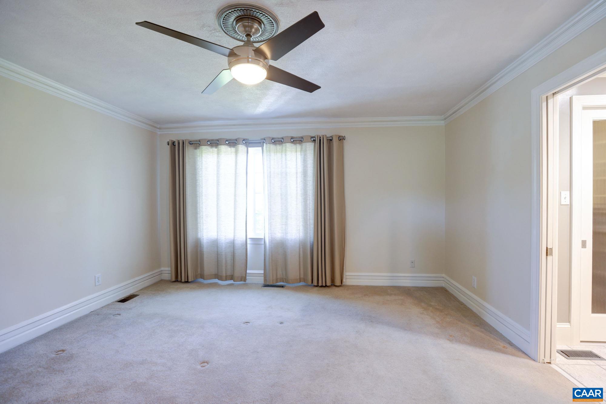 843 Campbell Road Keswick, VA 22947 - Photo 19 of 46 an empty room with a window and a fan