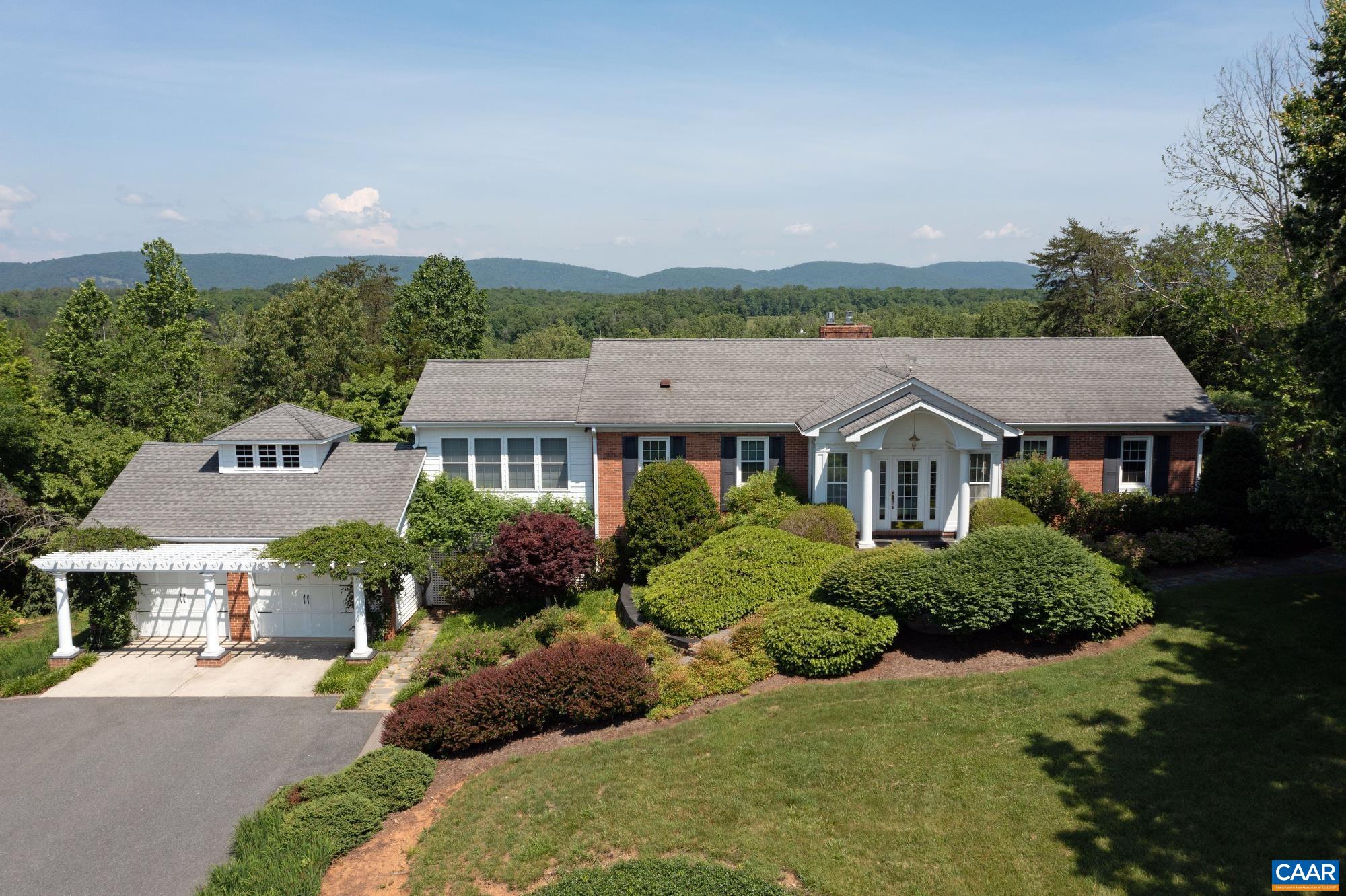 843 Campbell Road Keswick, VA 22947 - Photo 2 of 46 a front view of a house with a garden