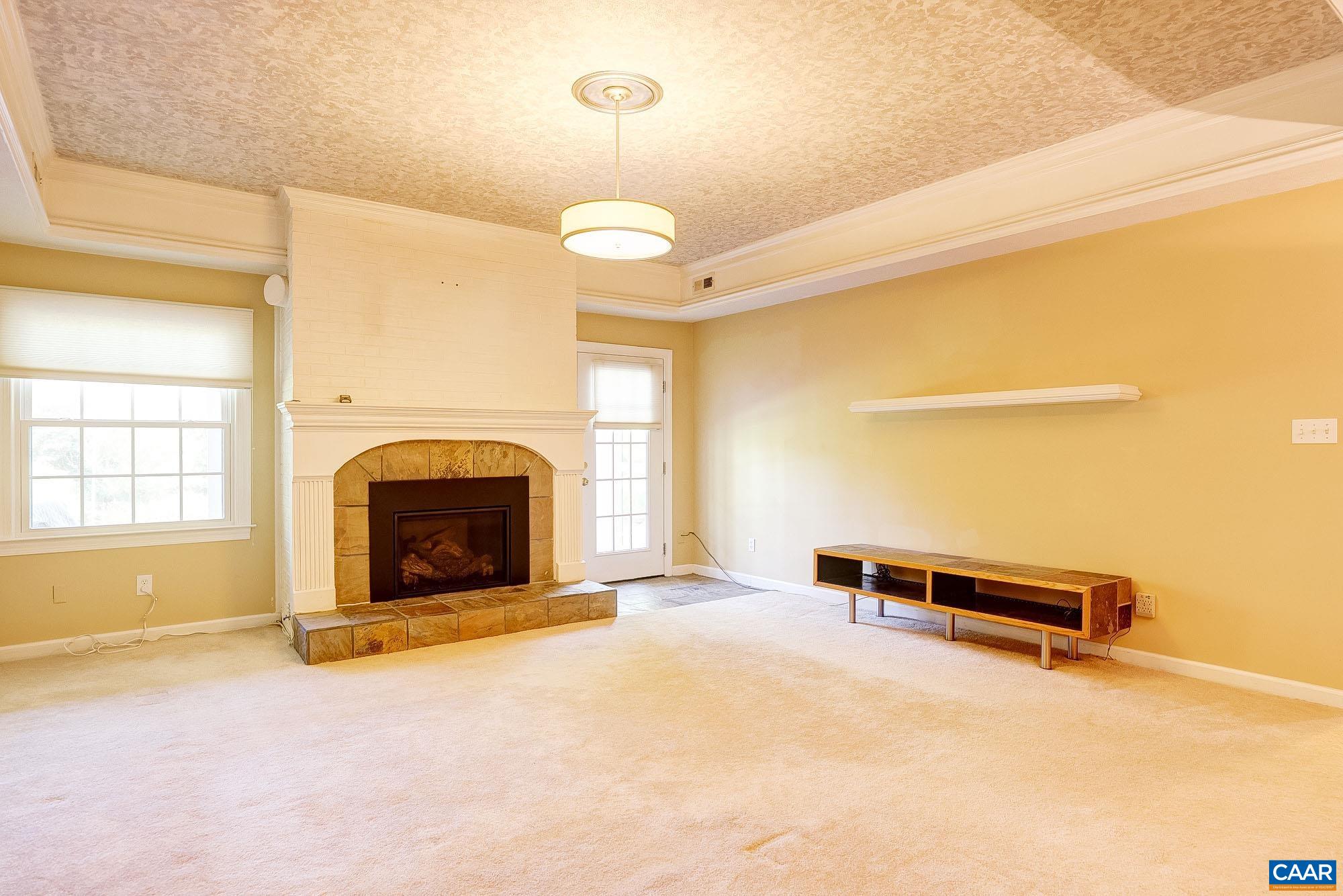 843 Campbell Road Keswick, VA 22947 - Photo 24 of 46 a view of a livingroom with a fireplace and a window