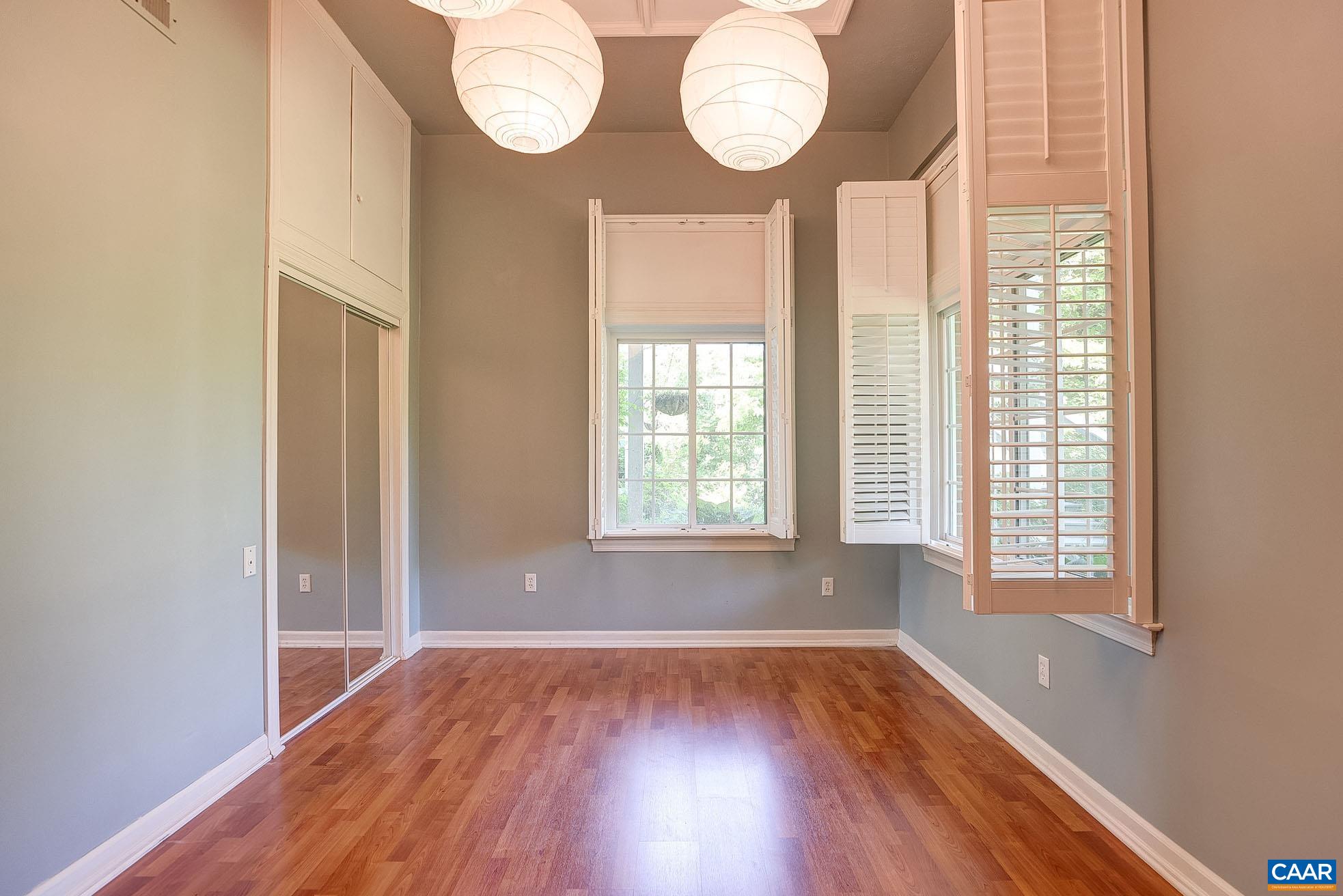 843 Campbell Road Keswick, VA 22947 - Photo 26 of 46 an empty room with wooden floor and windows
