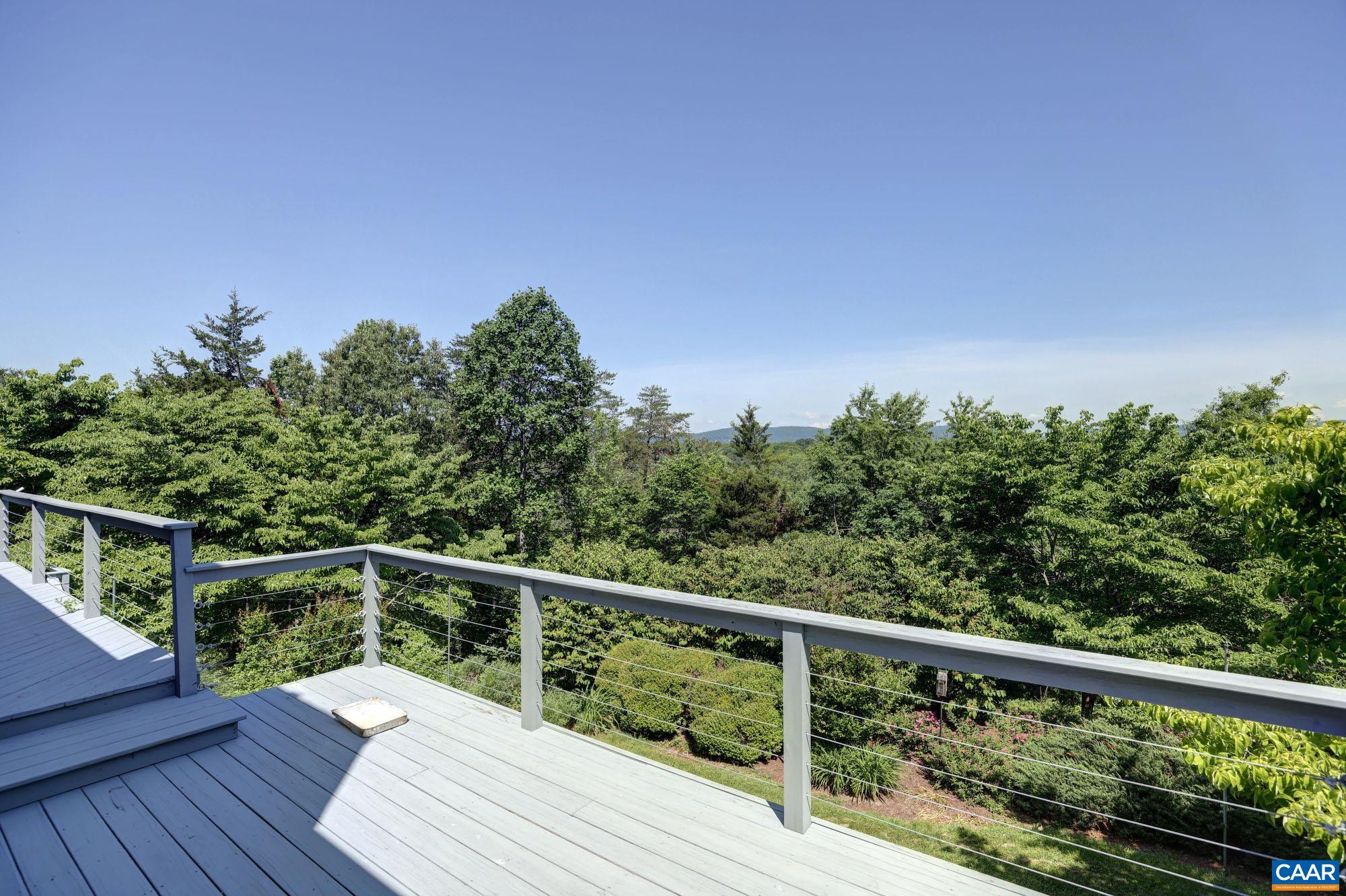843 Campbell Road Keswick, VA 22947 - Photo 40 of 46 a view of a balcony with wooden floor and fence