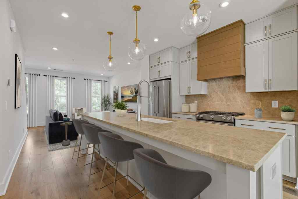 a kitchen with stainless steel appliances granite countertop a sink a stove and a refrigerator