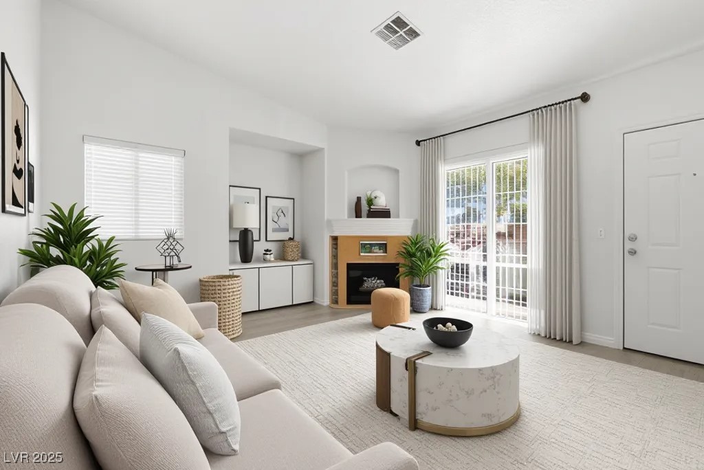 Virtually Staged - Spacious living room with slider to front balcony and cozy fireplace