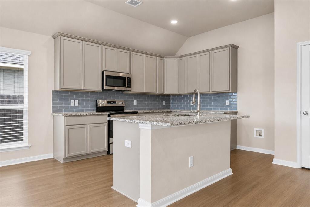 3213 Dottavio Road Lorena, TX 76655 - Photo 8 of 32 a kitchen with granite countertop white cabinets sink and stainless steel appliances
