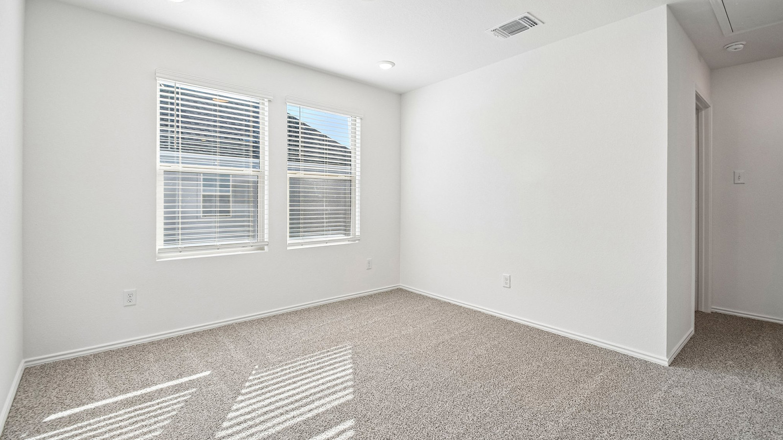 388 Old Stage Coach Road Jarrell, TX 76537 - Photo 14 of 30 Double windows fill this carpeted bedroom with natural light.
