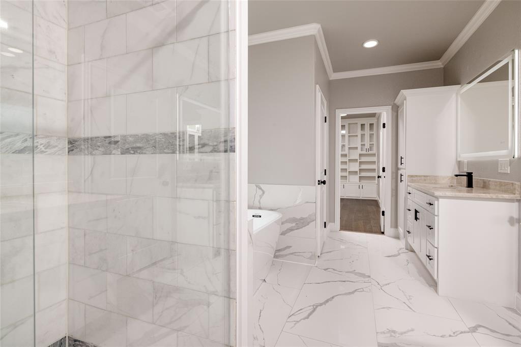 7196 Hawkeye Road Sanger, TX 76266 - Photo 18 of 26 Full bathroom with crown molding, tiled shower, vanity, and a freestanding tub