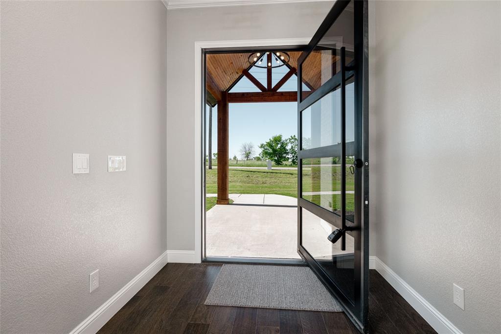 7196 Hawkeye Road Sanger, TX 76266 - Photo 19 of 26 Entryway with baseboards, dark wood finished floors, and a textured wall