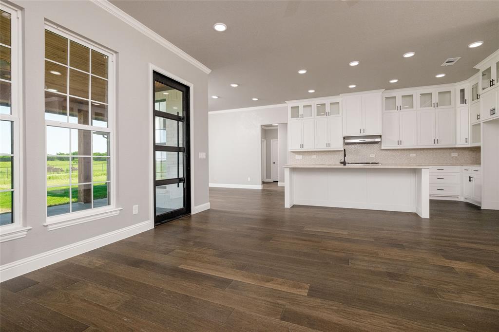 7196 Hawkeye Road Sanger, TX 76266 - Photo 7 of 26 Kitchen featuring crown molding, dark wood-type flooring, light countertops, decorative backsplash, and recessed lighting