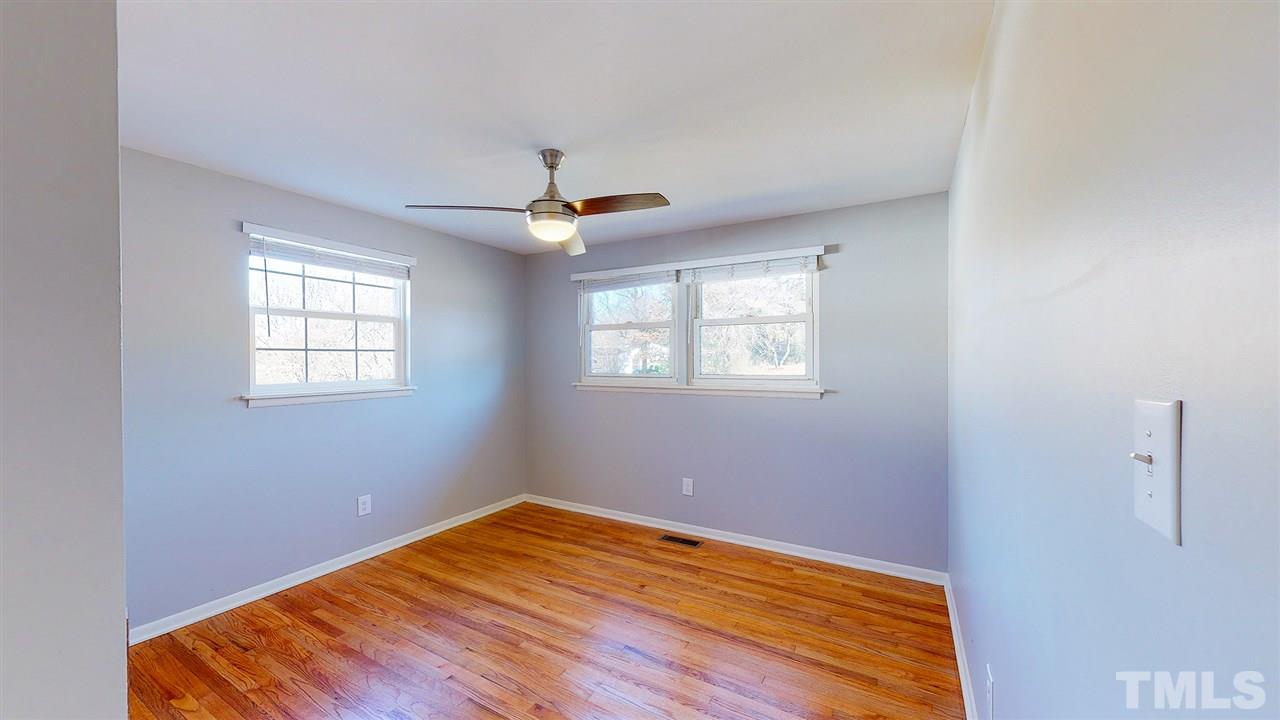 708 Hadley Road Raleigh, NC 27610 - Photo 11 of 20 a view of empty room with wooden floor and fan