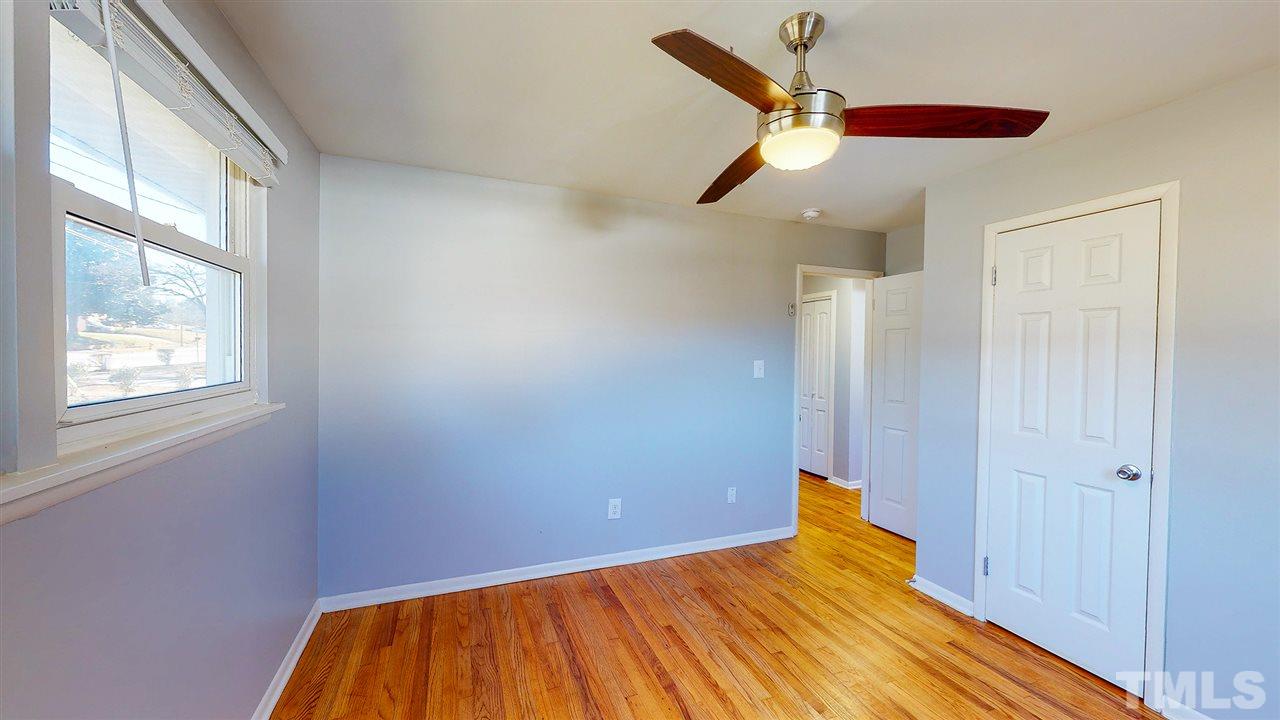 708 Hadley Road Raleigh, NC 27610 - Photo 12 of 20 a view of empty room with wooden floor and fan