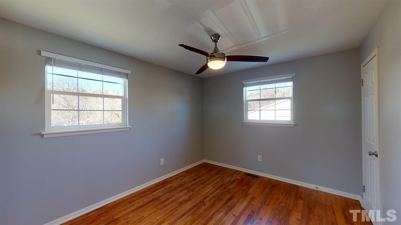 708 Hadley Road Raleigh, NC 27610 - Photo 13 of 20 a view of empty room with wooden floor and fan