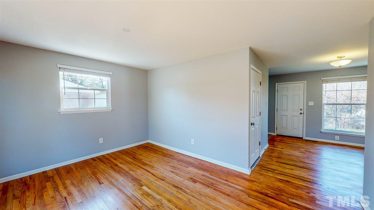 708 Hadley Road Raleigh, NC 27610 - Photo 4 of 20 a view of empty room with wooden floor and fan