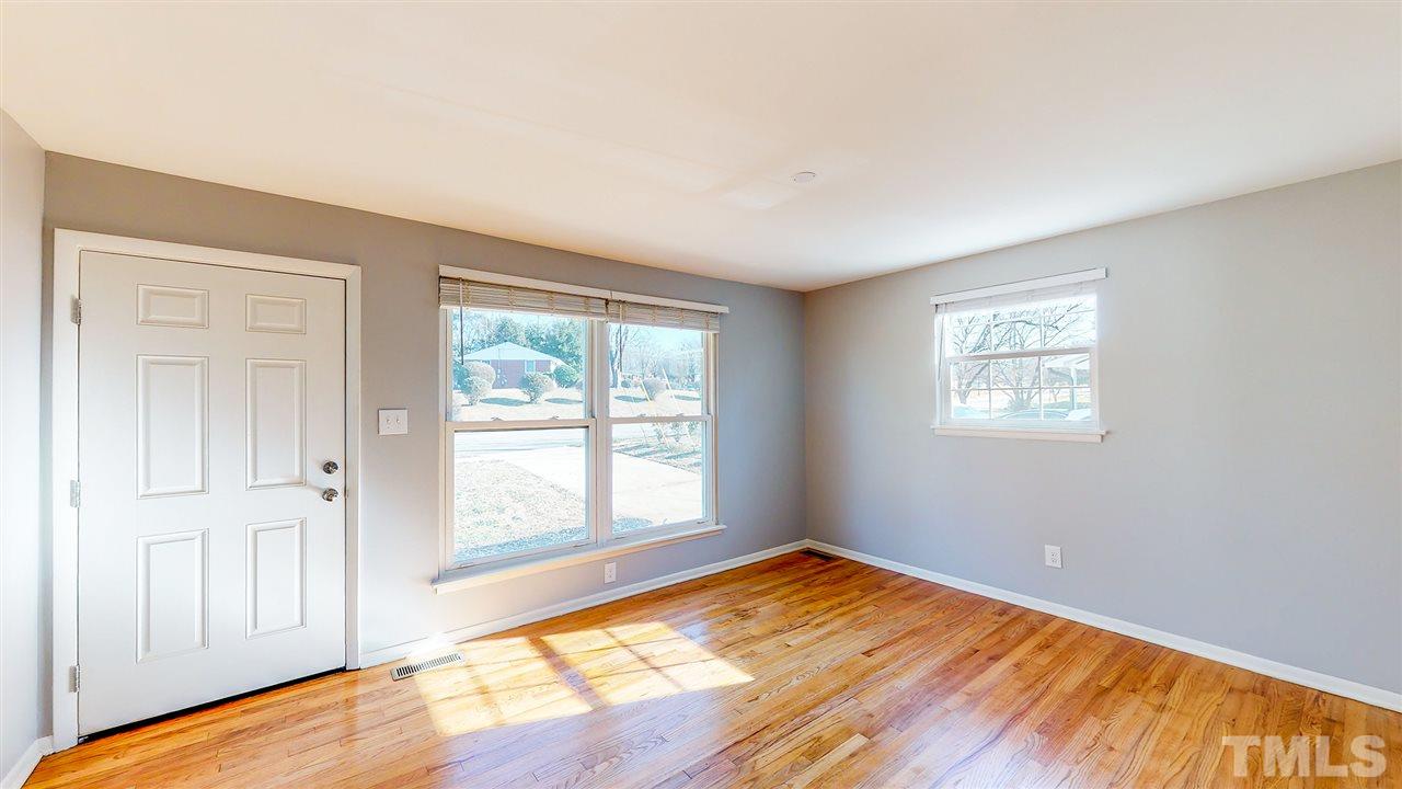 708 Hadley Road Raleigh, NC 27610 - Photo 5 of 20 a view of empty room with wooden floor and fan