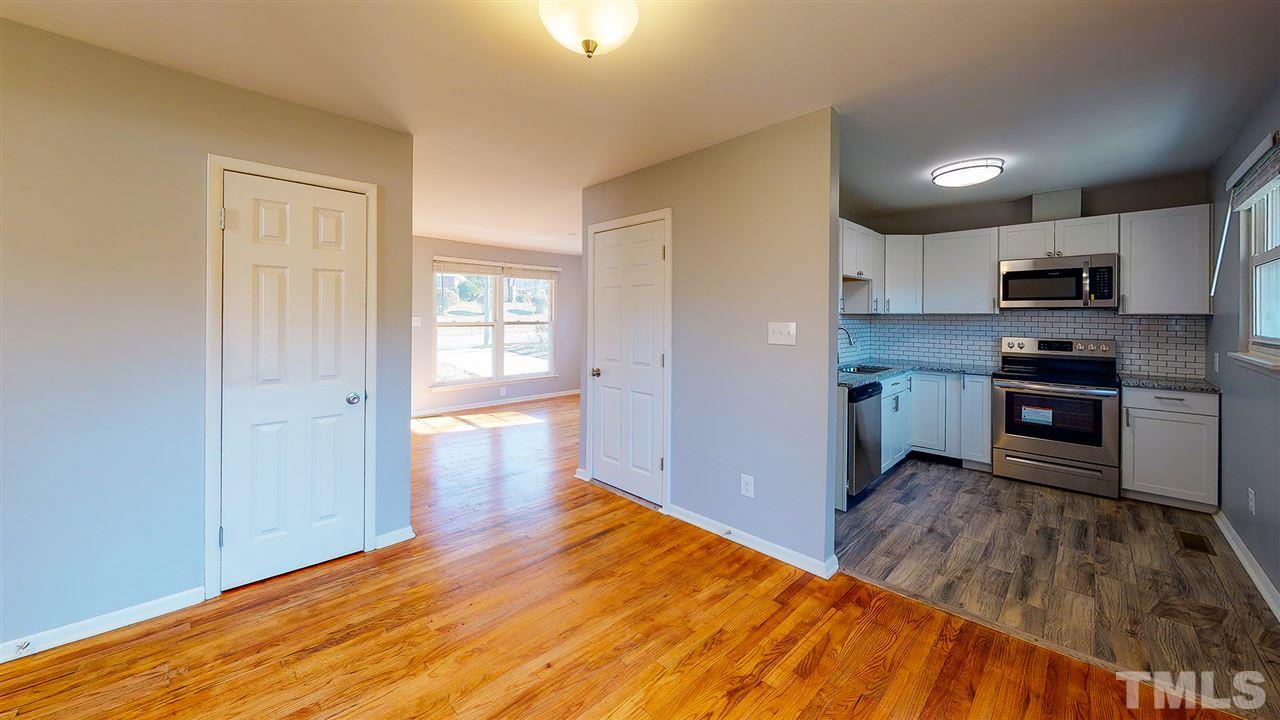 708 Hadley Road Raleigh, NC 27610 - Photo 6 of 20 a kitchen with granite countertop a stove a sink and a refrigerator