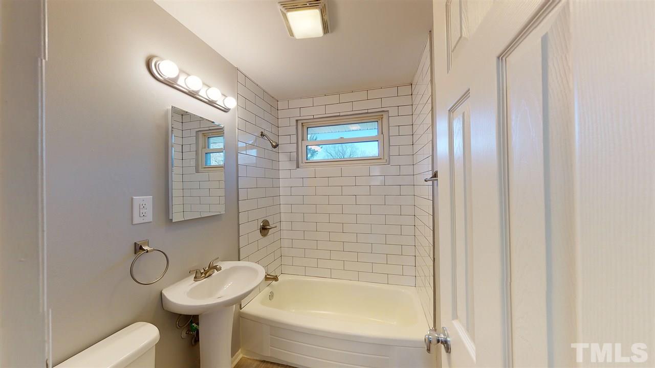 708 Hadley Road Raleigh, NC 27610 - Photo 9 of 20 a bathroom with a sink toilet and shower