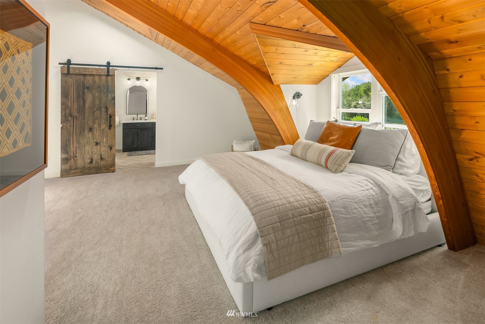 17227 Southeast May Valley Road Renton, WA 98059 - Photo 19 of 40 a spacious bedroom with a bed and a large window