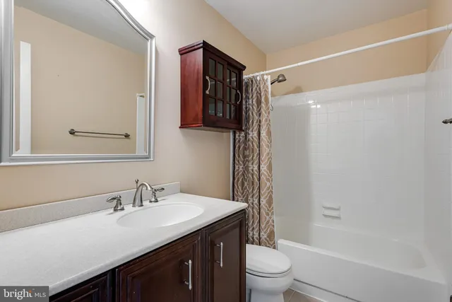 a bathroom with a double vanity sink toilet and shower