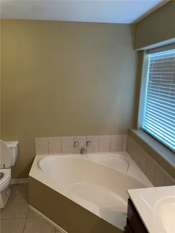 a view of backyard with swimming pool and seating area