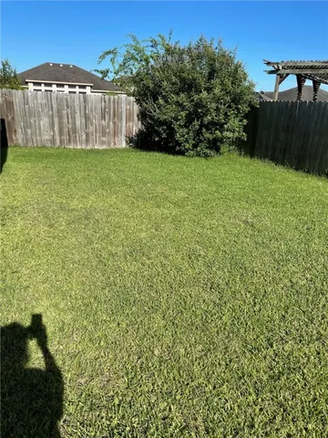 a view of a backyard with a fence
