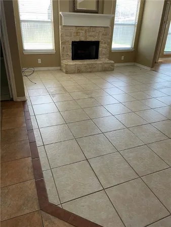 a view of a livingroom with a fireplace and window