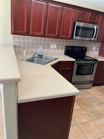 a kitchen with a sink and cabinets
