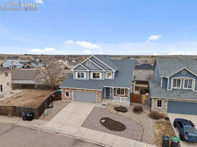 an aerial view of a house with a yard