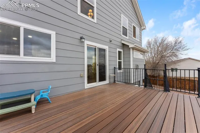 a view of a house with a wooden deck