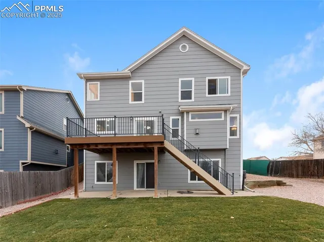 a view of a house with a yard balcony and seating area