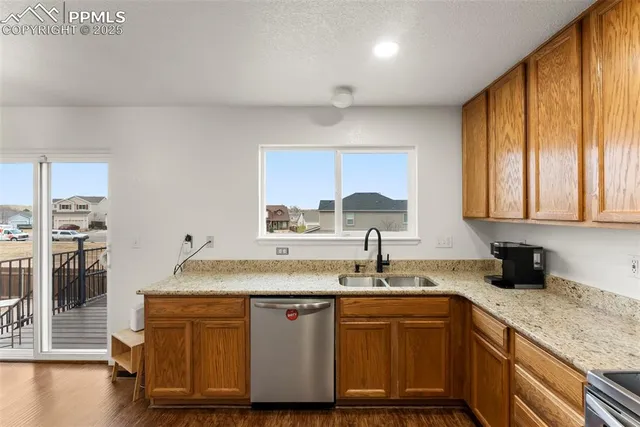 a kitchen with stainless steel appliances granite countertop a sink a microwave cabinets and a counter space