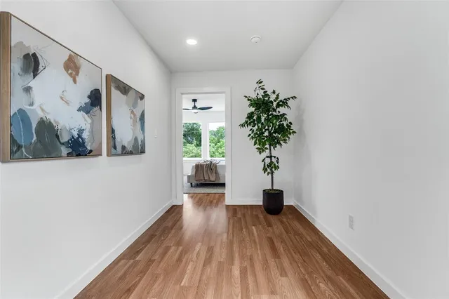 a view of a room with wooden floor and a potted plant