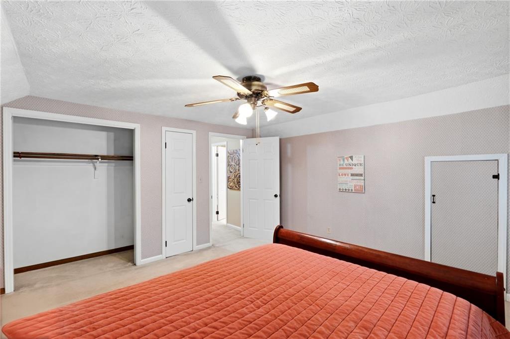 3121 Bonds Lake Road Northwest Conyers, GA 30012 - Photo 20 of 36 a bedroom with a bed and a ceiling fan