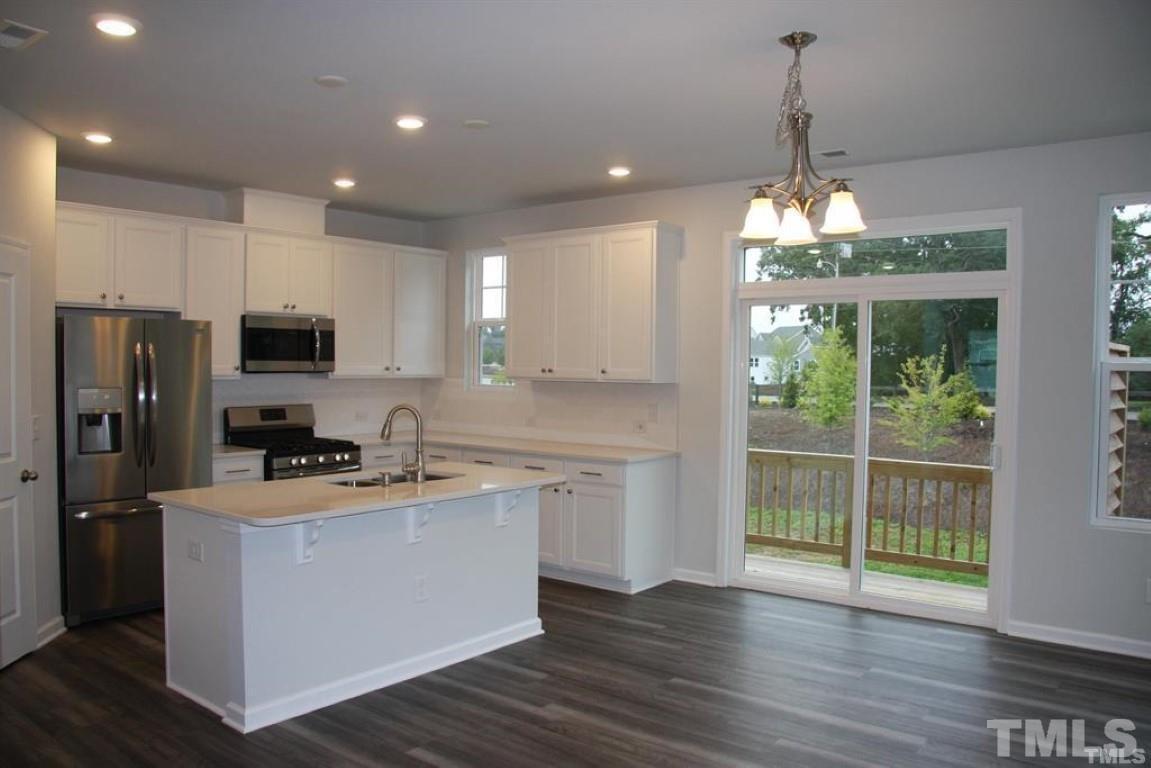 2919 Sunflower Road Apex, NC 27502 - Photo 13 of 34 a kitchen that has a lot of cabinets and stainless steel appliances