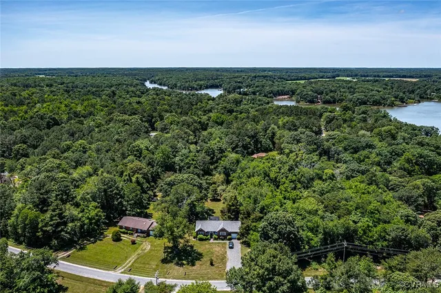 an aerial view of a house with a yard