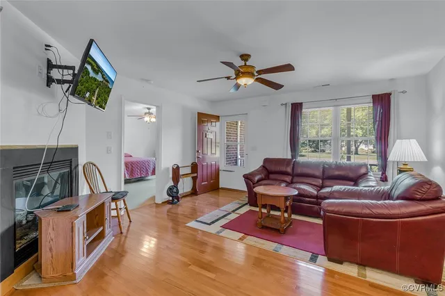 a living room with furniture a dining table and chairs with wooden floor