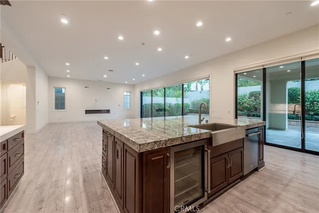 a kitchen with granite countertop kitchen island a sink and a stove