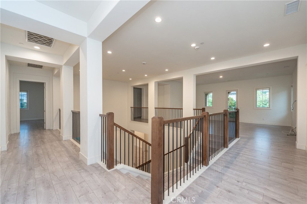93 Spacial Irvine, CA 92618 - Photo 16 of 32 a view of a hallway with wooden floor and windows