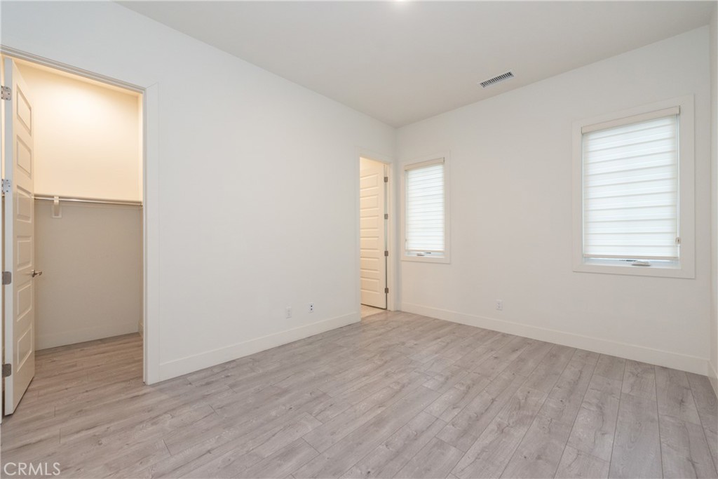 93 Spacial Irvine, CA 92618 - Photo 19 of 32 an empty room with wooden floor and windows