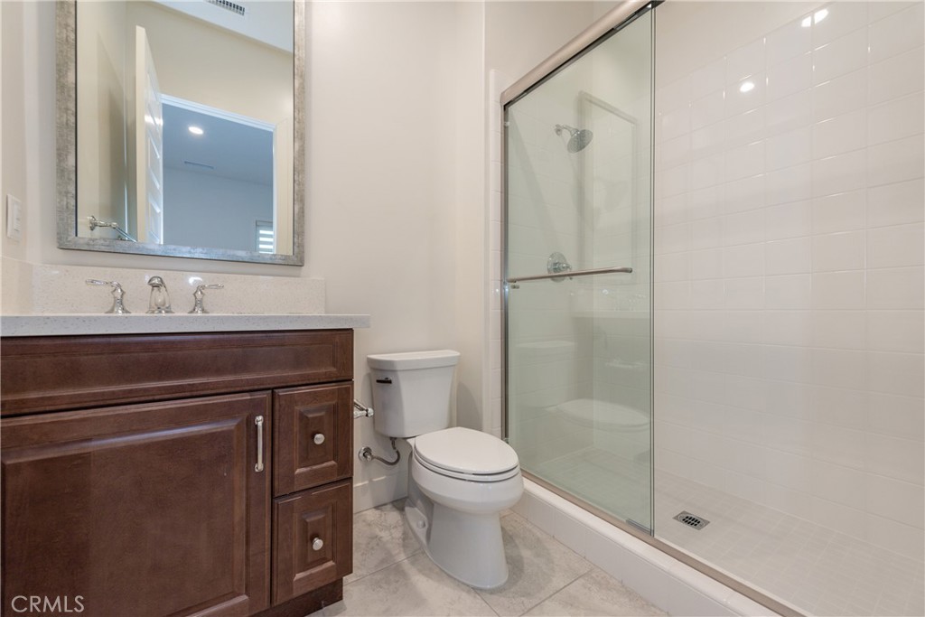 93 Spacial Irvine, CA 92618 - Photo 25 of 32 a bathroom with a sink a toilet and shower