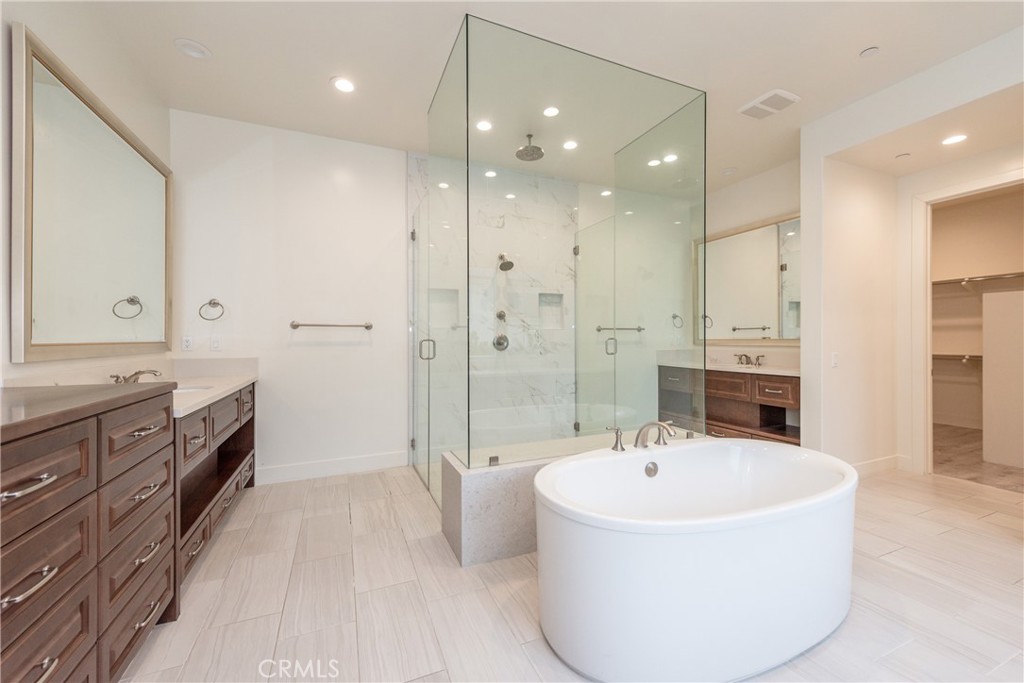 93 Spacial Irvine, CA 92618 - Photo 29 of 32 a bathroom with a tub sink shower and mirror