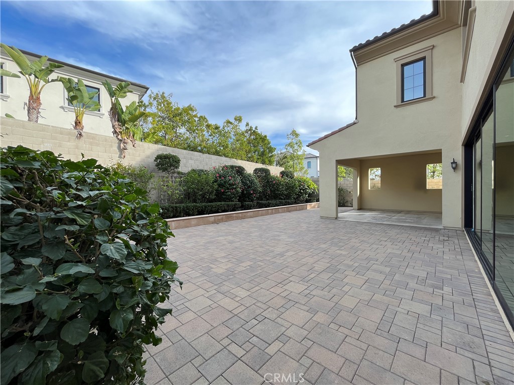 93 Spacial Irvine, CA 92618 - Photo 30 of 32 a view of a house with a yard and potted plants