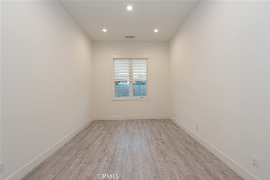 93 Spacial Irvine, CA 92618 - Photo 3 of 32 an empty room with wooden floor and windows