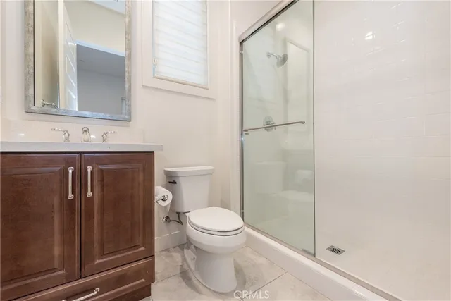 a bathroom with a toilet a sink and shower
