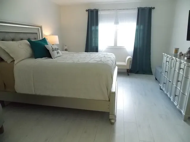 a bedroom with a bed and a window