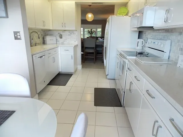 a kitchen with a sink a stove and cabinets