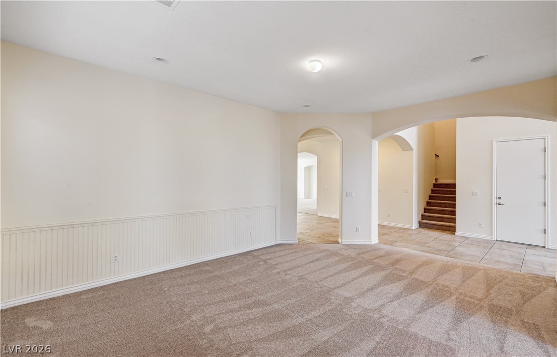 6761 Clay TABLET Street Las Vegas, NV 89149 - Photo 11 of 73 Arched doorways connect the carpeted living space to the tile-floored entry hall.
