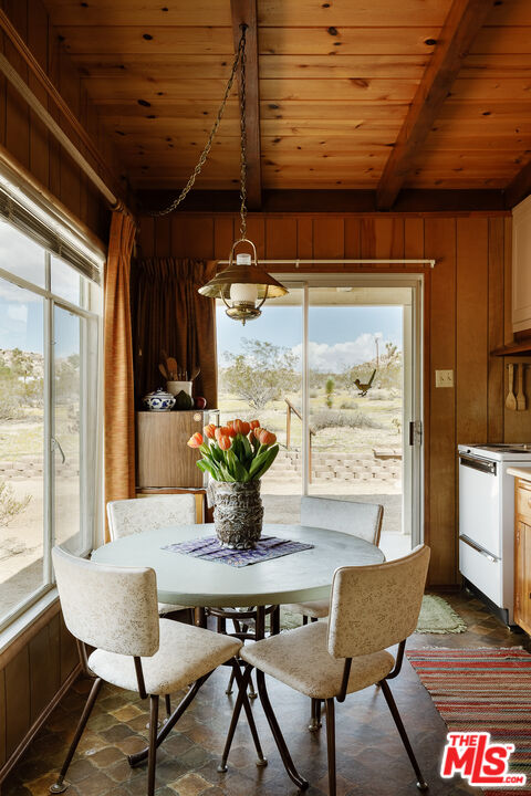 63670 Wagon Wheel Road Joshua Tree, CA 92252 - Photo 11 of 37 a view of a dining room with furniture window and outside view