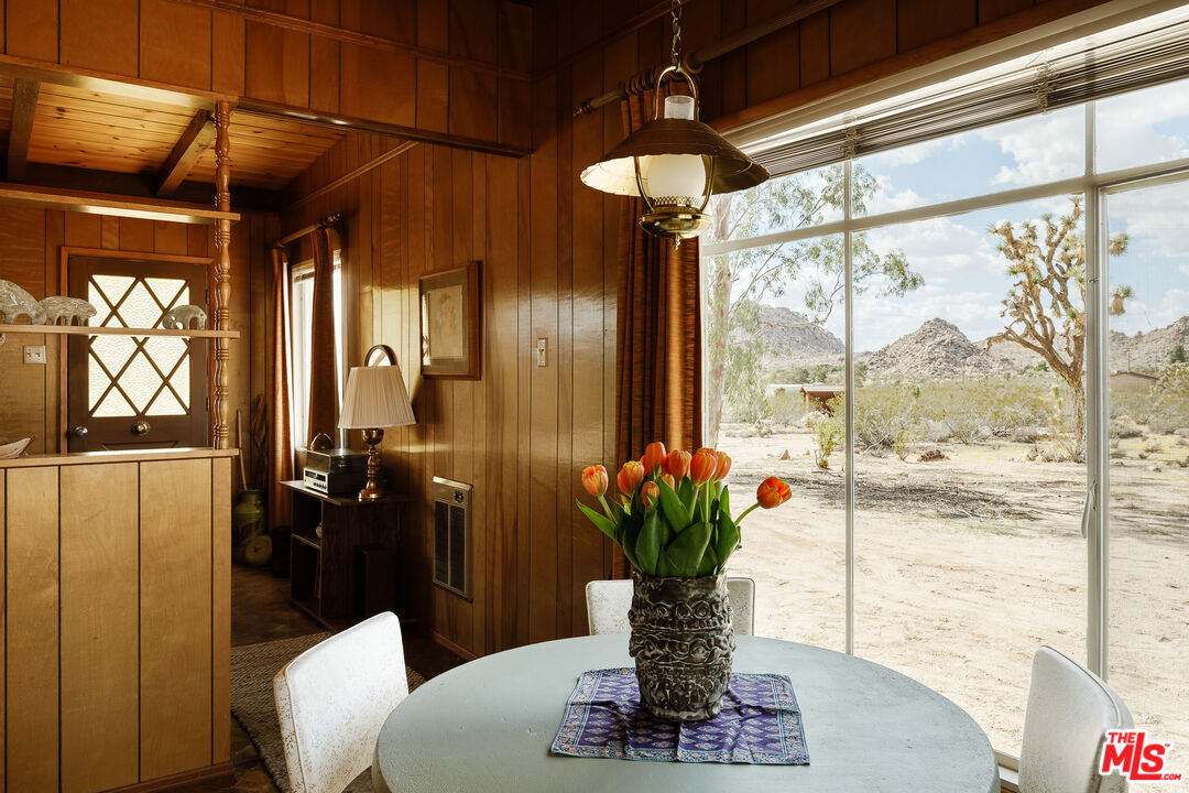 63670 Wagon Wheel Road Joshua Tree, CA 92252 - Photo 14 of 37 a vase of flowers sitting on a table with window