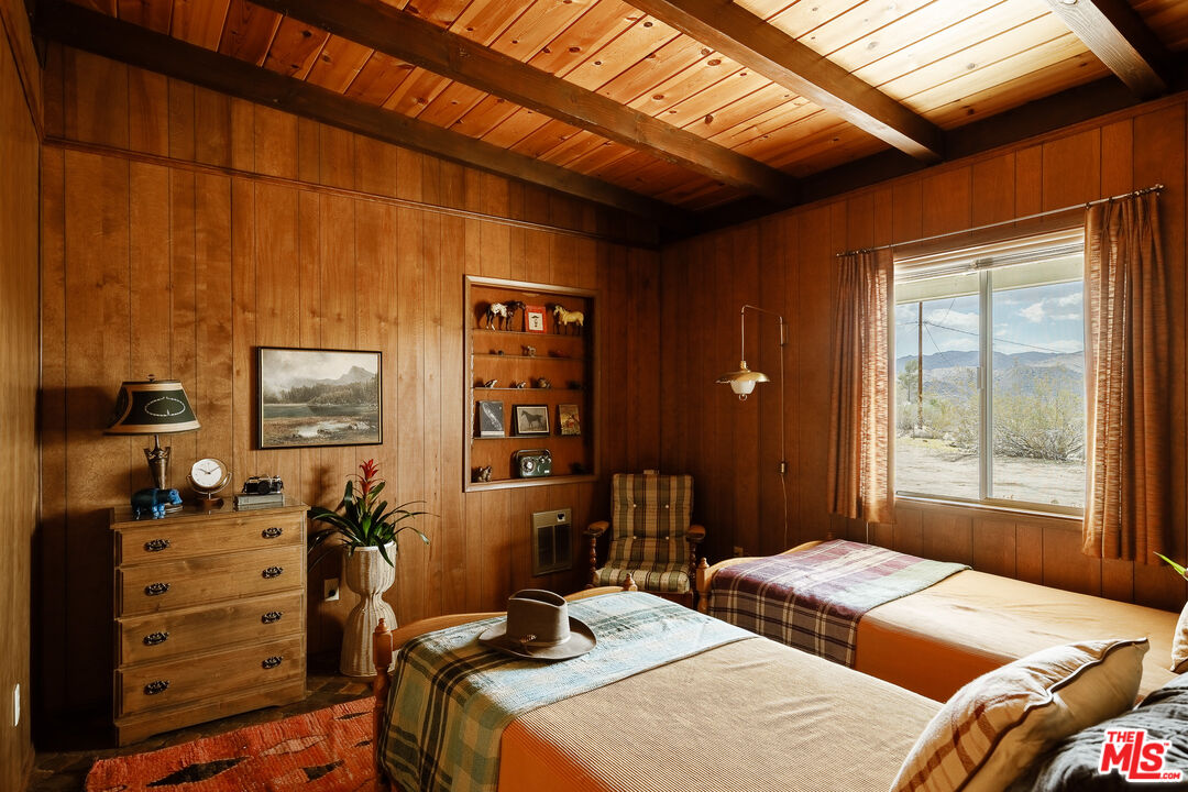 63670 Wagon Wheel Road Joshua Tree, CA 92252 - Photo 15 of 37 a bedroom with a bed and a window